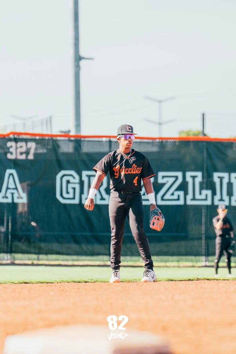 Kai Watts at shortstop in the black Grizzlies #4 jersey, in front of the California Grizzlies outfield banner